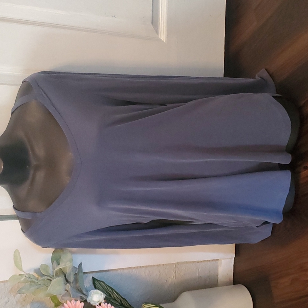 womens long sleeve blouse. Med blue cove in color and open at the shoulders.